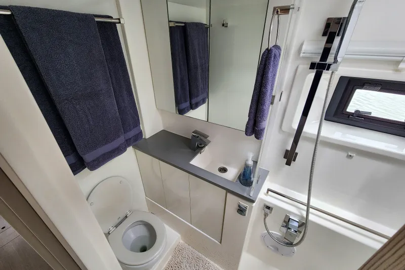 Slide: The Image of Modern bathroom in a 2020 Leopard 45 yacht with sleek fixtures and dark towels. - 100
