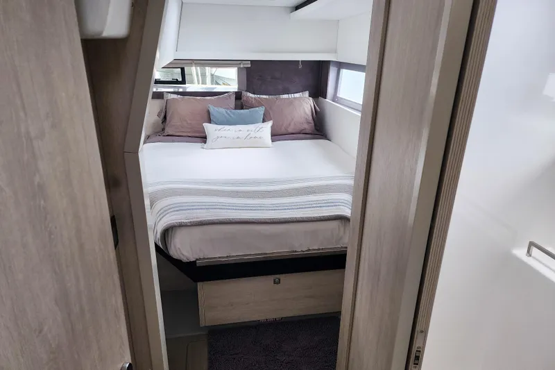 Slide: The Image of Cozy bedroom interior in a 2020 Leopard 45 yacht, featuring a neatly made bed. - 101
