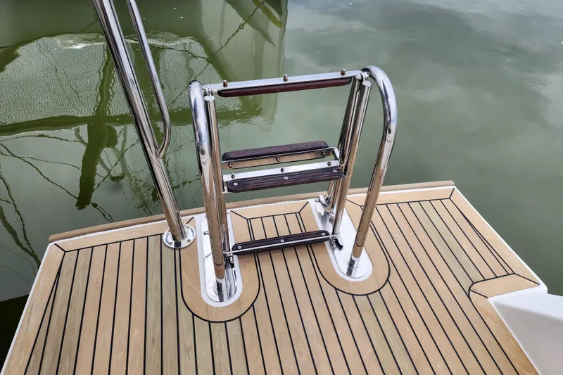 Slide: The Image of Stainless steel swim ladder on a 2020 Leopard 45 yacht's teak deck. - 11