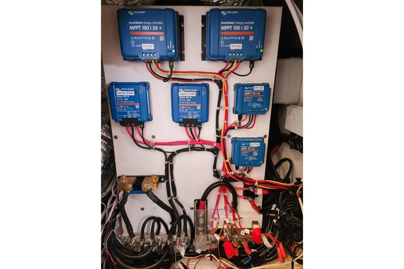 Slide: The Image of Electrical panel with Victron Energy charge controllers on a 2020 Leopard 45 model. - 112