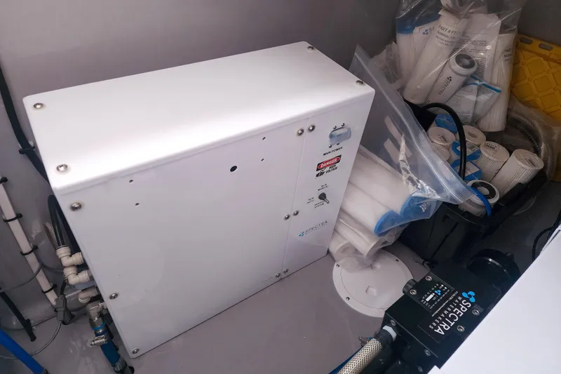 Slide: The Image of Water filtration system in a 2020 Leopard 45 yacht, featuring Spectra components and spare filters. - 119