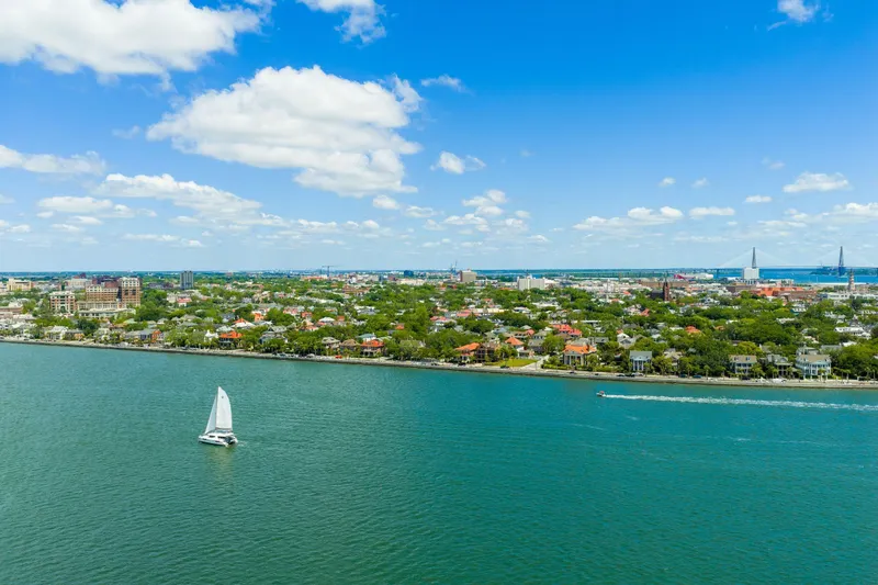 Slide: The Image of Aerial view of a Leopard 45 sailboat on a sunny day near a coastal city. - 124