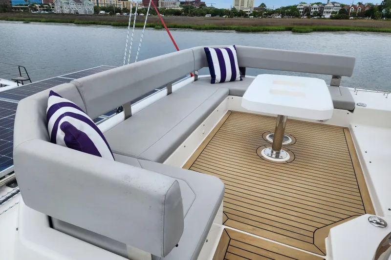 Slide: The Image of Luxurious seating area on 2020 Leopard 45 yacht with striped cushions and wooden deck. - 16