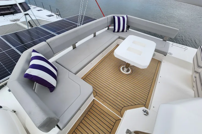 Slide: The Image of Luxurious Leopard 45 yacht deck with seating, table, and striped cushions, 2020 model. - 21