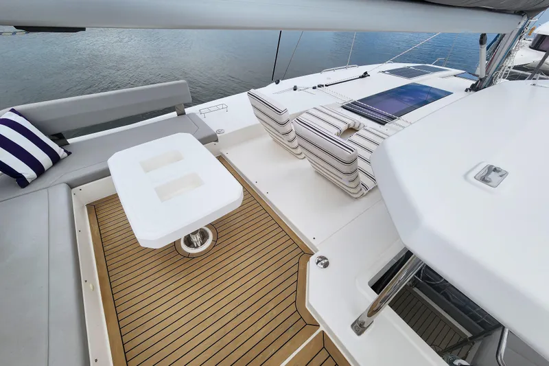 Slide: The Image of Luxurious deck of 2020 Leopard 45 catamaran with seating and table, overlooking water. - 22