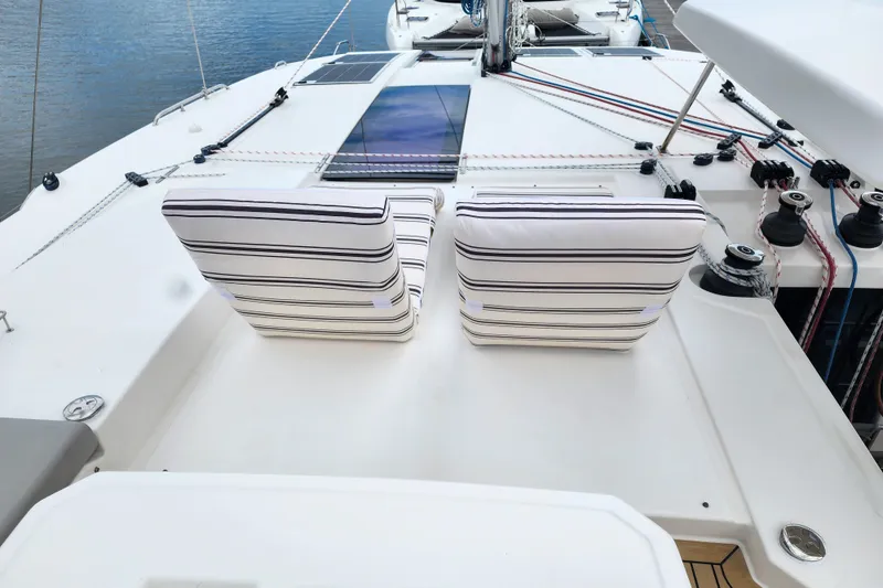 Slide: The Image of Deck of 2020 Leopard 45 catamaran with striped cushions and sailing equipment. - 23