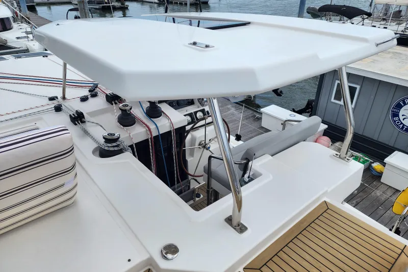Slide: The Image of 2020 Leopard 45 yacht helm station with canopy and marina view. - 24