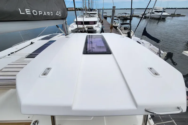 Slide: The Image of 2020 Leopard 45 catamaran docked at marina, showcasing sleek deck design. - 25