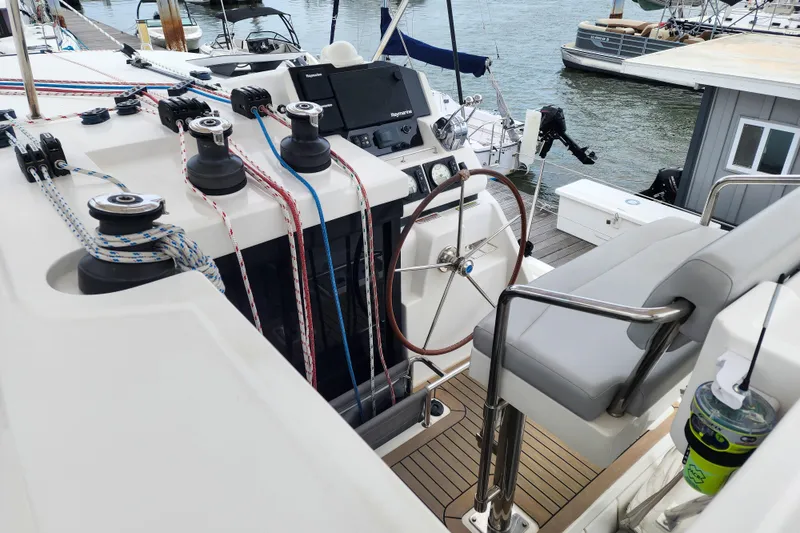 Slide: The Image of Helm of 2020 Leopard 45 catamaran with steering wheel, ropes, and navigation equipment. - 26