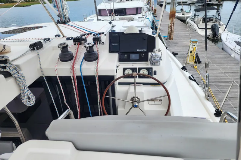 Slide: The Image of Cockpit of a 2020 Leopard 45 catamaran with steering wheel and navigation equipment. - 27