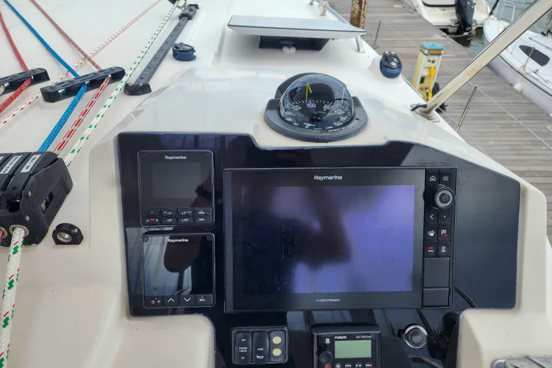 Slide: The Image of Control panel of a 2020 Leopard 45 catamaran with navigation instruments and ropes. - 32