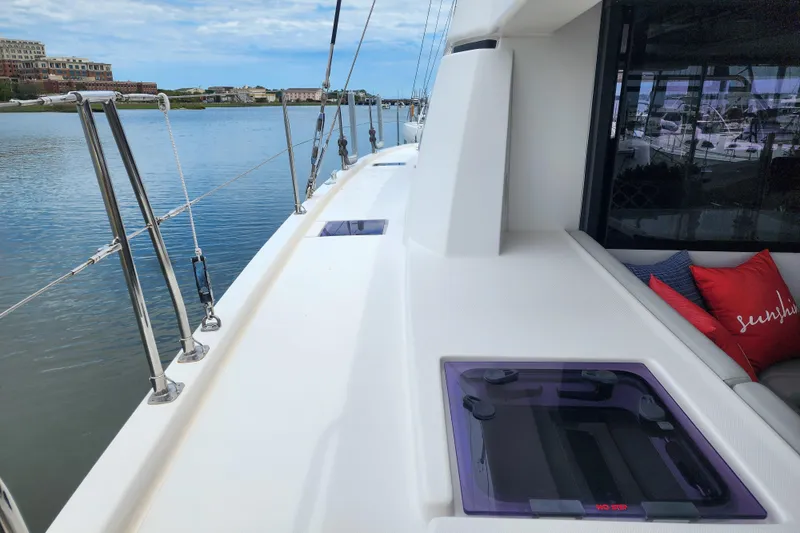 Slide: The Image of Deck view of a 2020 Leopard 45 catamaran with scenic waterfront background. - 34
