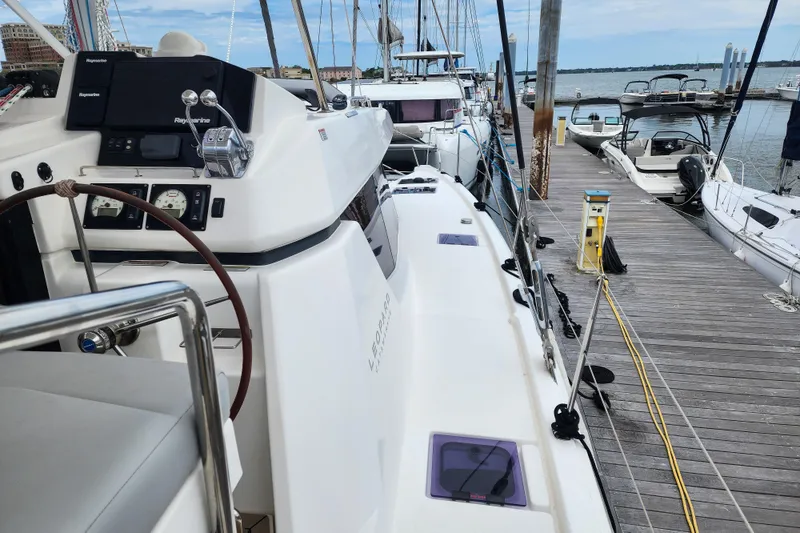 Slide: The Image of Leopard 45 catamaran docked at marina, showcasing helm and deck, 2020 model. - 38