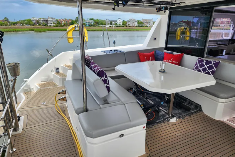 Slide: The Image of Luxurious Leopard 45 yacht deck with seating, table, and scenic waterfront view. - 4