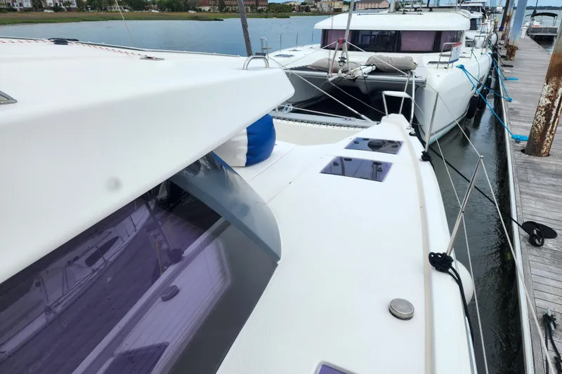 Slide: The Image of 2020 Leopard 45 catamaran docked at marina, showcasing sleek design and spacious deck. - 42
