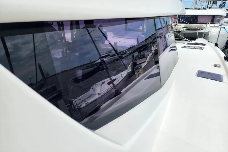 Slide: The Image of 2020 Leopard 45 yacht with reflective windows, docked at a marina. - 43