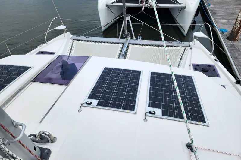 Slide: The Image of 2020 Leopard 45 catamaran with solar panels on deck, docked at marina. - 45