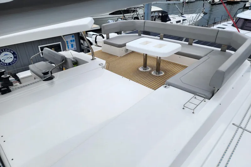 Slide: The Image of 2020 Leopard 45 yacht deck with seating and table at marina. - 49