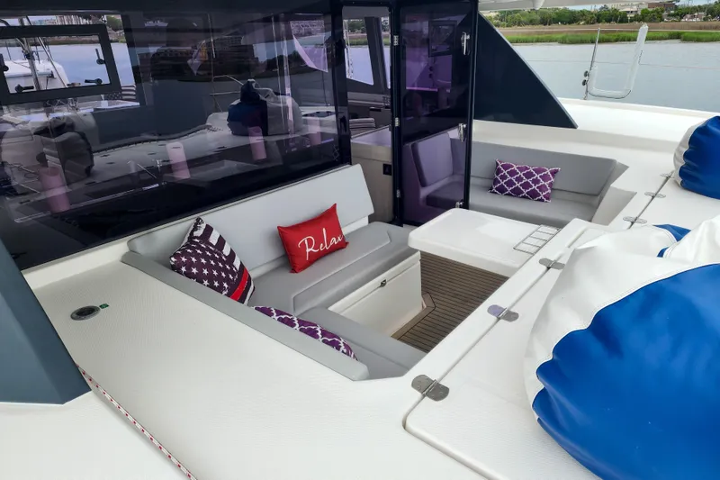 Slide: The Image of Luxurious seating area on a 2020 Leopard 45 yacht with decorative pillows and modern design. - 53