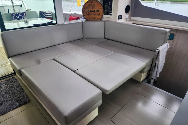 Slide: The Image of Luxurious interior seating on a 2020 Leopard 45 catamaran, featuring plush gray cushions. - 61