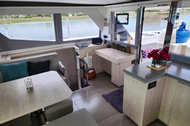 Slide: The Image of Modern interior of a 2020 Leopard 45 catamaran with dining area and scenic water view. - 62