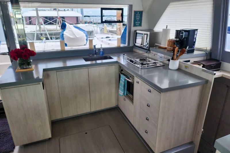 Slide: The Image of Modern kitchen interior on a 2020 Leopard 45 yacht, featuring sleek countertops and appliances. - 64