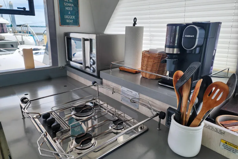 Slide: The Image of Modern kitchen in a 2020 Leopard 45 yacht with stove, microwave, and coffee maker. - 65