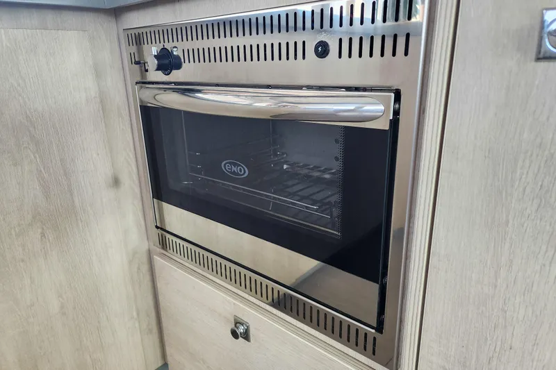 Slide: The Image of Built-in ENO oven in a Leopard 45 yacht, 2020 model, with wooden cabinetry. - 69