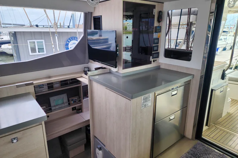 Slide: The Image of Modern interior of a 2020 Leopard 45 yacht with sleek cabinetry and a mounted TV. - 74