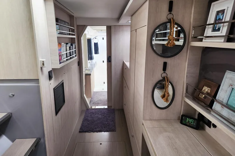 Slide: The Image of Modern interior of a 2020 Leopard 45 yacht with sleek wood finishes and decorative mirrors. - 86