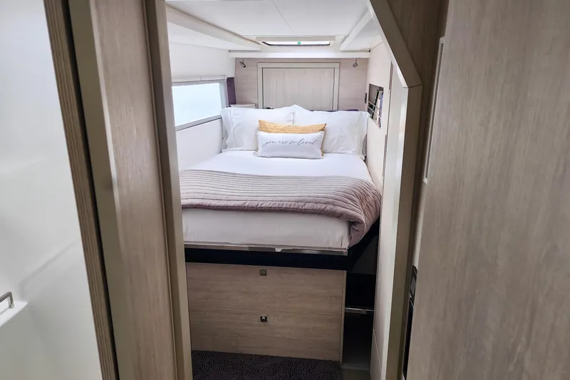Slide: The Image of Cozy bedroom interior in a 2020 Leopard 45 yacht, featuring a neatly made bed. - 95