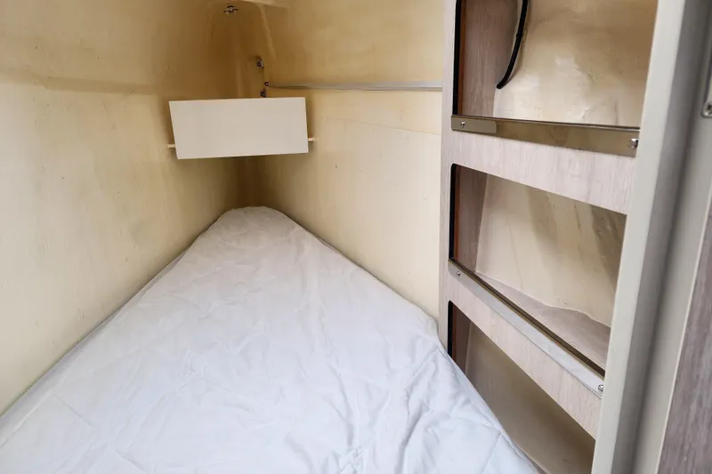 Slide: The Image of Cozy cabin interior of 2020 Leopard 45 yacht with a single bed and storage shelves. - 99