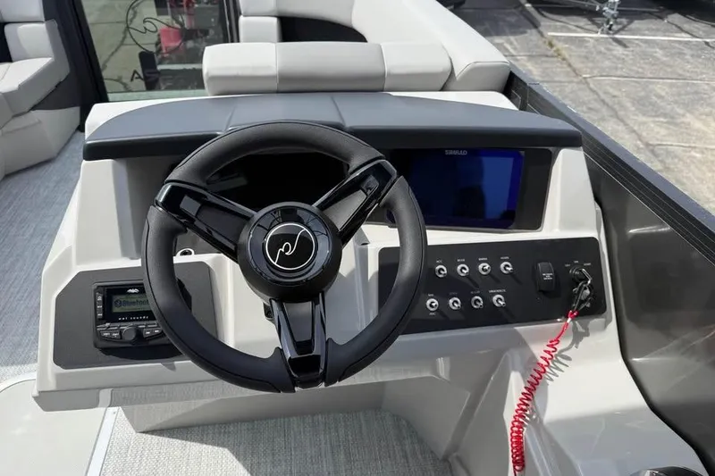 Slide: The Image of Steering console of 2026 Alera 22l boat with modern controls and display. - 10