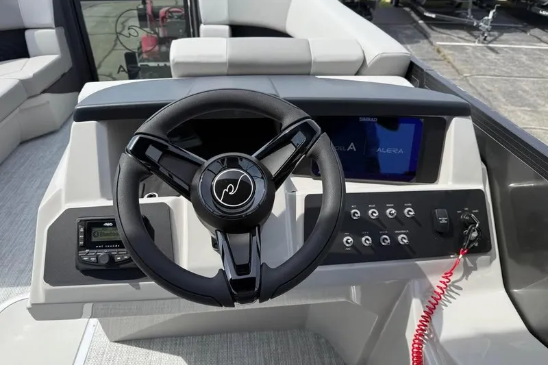 Slide: The Image of Steering console of 2026 Alera 22l boat with modern controls and display. - 11
