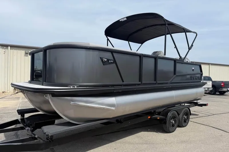 Slide: The Image of 2026 Alera 22l pontoon boat on trailer, featuring sleek black design and canopy. - 3