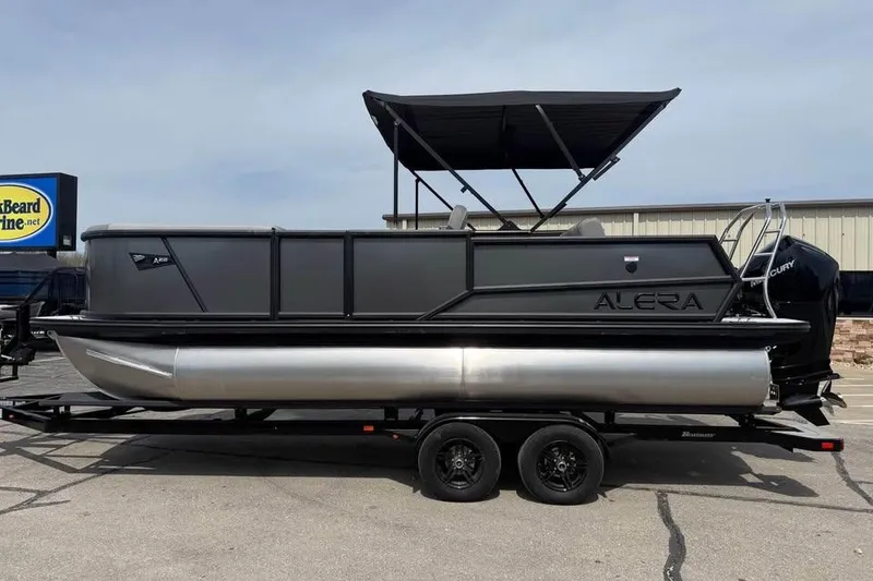 Slide: The Image of 2026 Alera 22L pontoon boat with canopy on trailer, parked outdoors. - 4