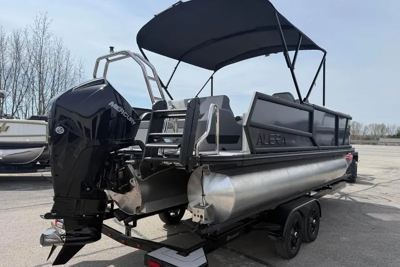 Slide: The Image of 2026 Alera 22l pontoon boat with Mercury engine, parked on trailer. - 7