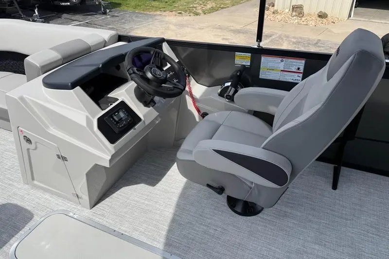 Slide: The Image of Captain's chair and helm of 2026 Alera 22l boat, featuring modern controls and dashboard. - 9