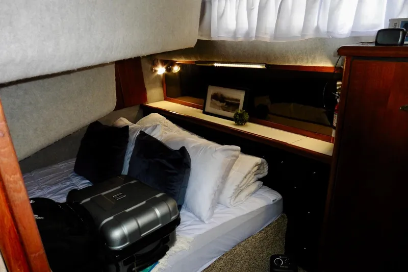 Slide: The Image of Cozy cabin interior of 1988 Bayliner 3888 Motoryacht with bed and luggage. - 12