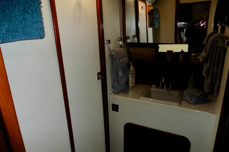 Slide: The Image of 1988 Bayliner 3888 Motoryacht bathroom with sink, mirror, and towels. - 13