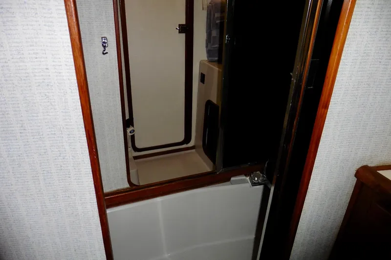 Slide: The Image of 1988 Bayliner 3888 Motoryacht bathroom interior with shower and wooden trim. - 14