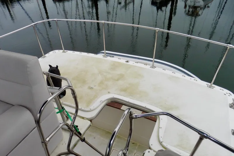 Slide: The Image of 1988 Bayliner 3888 Motoryacht deck with railing and seating, docked at marina. - 17