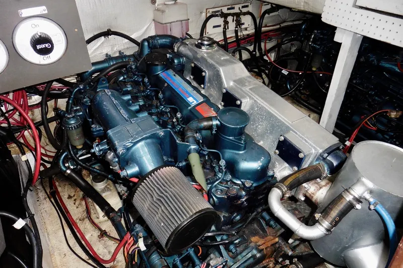 Slide: The Image of Engine room of a 1988 Bayliner 3888 Motoryacht with visible machinery and wiring. - 19