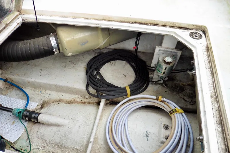 Slide: The Image of 1988 Bayliner 3888 Motoryacht engine compartment with hoses and wiring. - 21