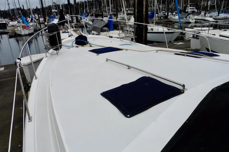 Slide: The Image of 1988 Bayliner 3888 Motoryacht docked at marina, showcasing spacious deck and railing. - 24