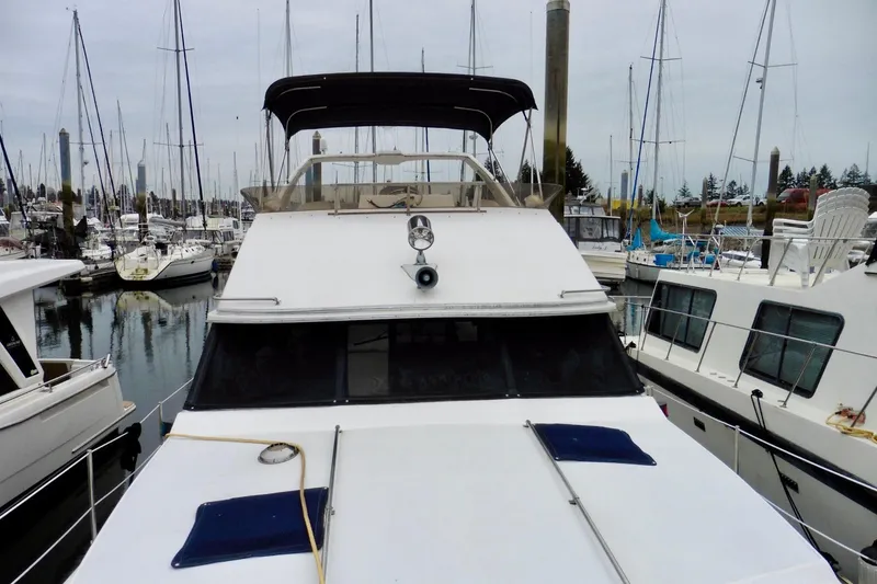 Slide: The Image of 1988 Bayliner 3888 Motoryacht docked at marina, surrounded by sailboats. - 26