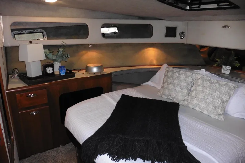 Slide: The Image of Cozy bedroom interior of 1988 Bayliner 3888 Motoryacht with elegant decor and soft lighting. - 32