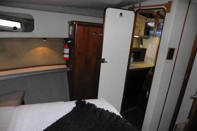 Slide: The Image of Interior of 1988 Bayliner 3888 Motoryacht cabin with bed, closet, and bathroom. - 33