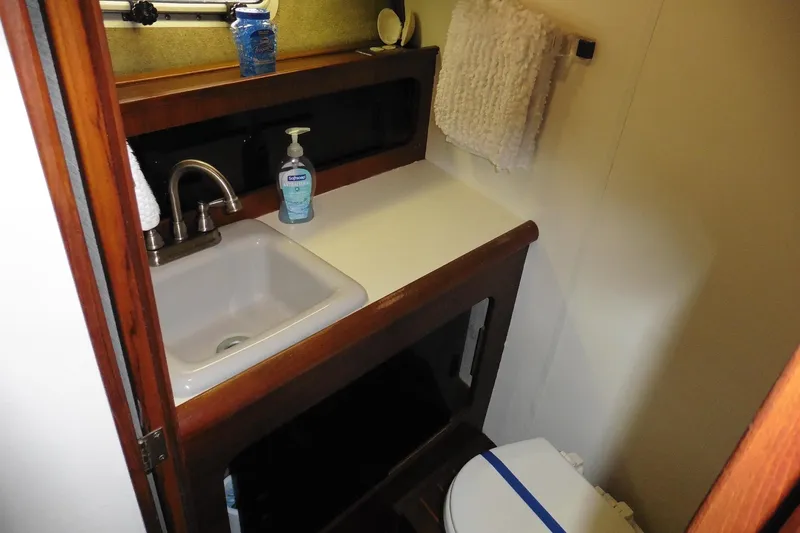 Slide: The Image of 1988 Bayliner 3888 Motoryacht bathroom with sink, faucet, and toilet. - 34