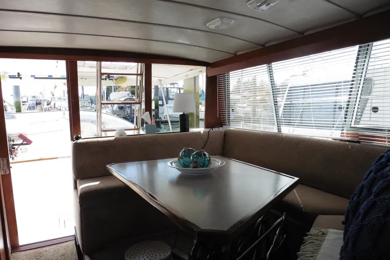 Slide: The Image of Interior of 1988 Bayliner 3888 Motoryacht with dining area and large windows. - 35